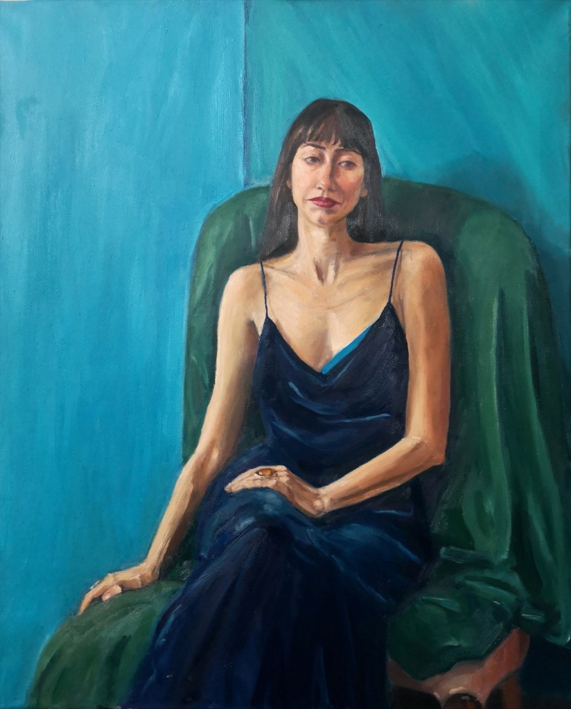 Waiting, Portrait a young lady in a navy velvet dress seated on a green armchair on a bright phtalo blue background made in oil paints on canvas, by Clara Niniewski