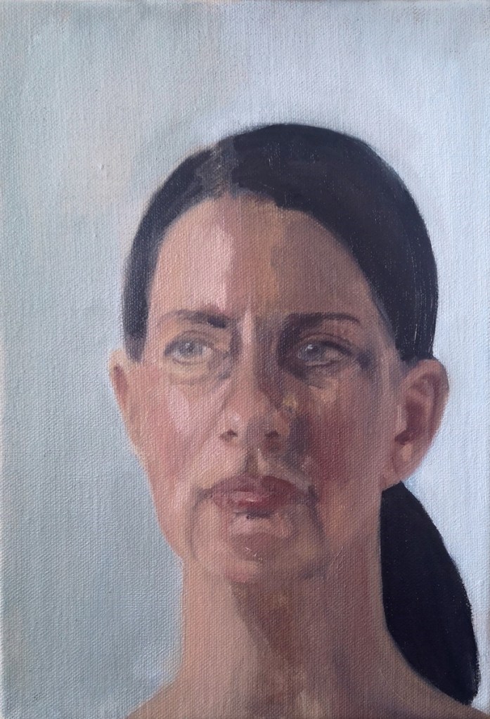 Head study in oil paints of Carla, woan with a ponytail on a light blue backgroud, painted from life by Clara Niniewski