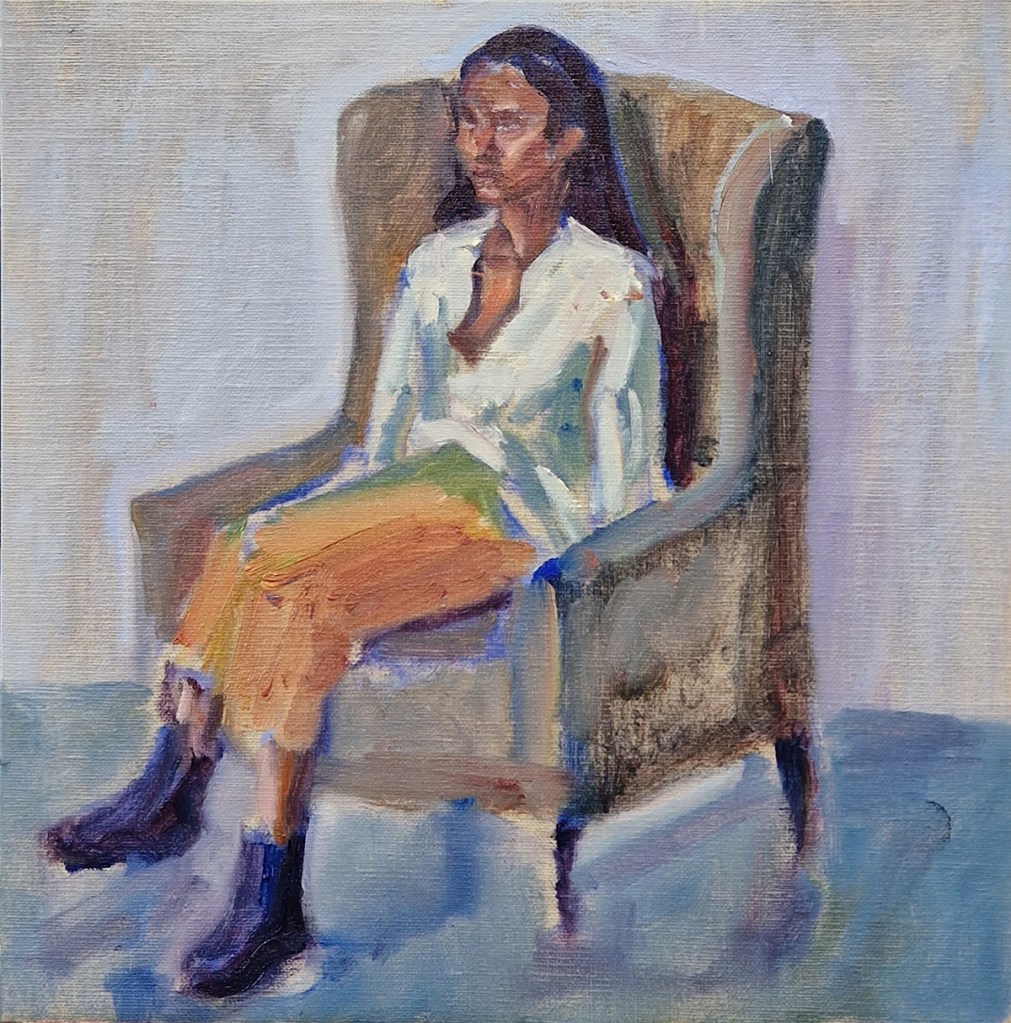 Shals seated, oil paint portrait study by Clara Niniewski of a brown skinned young lady seated in a big green armchair, wearing an orange skirt.